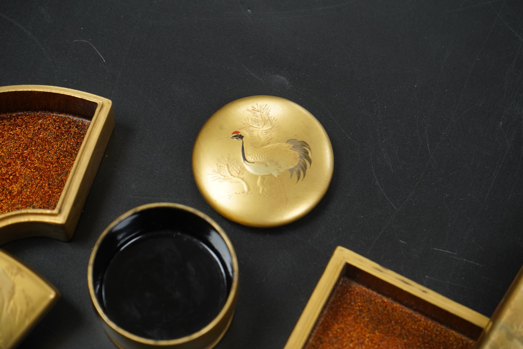 Three Japanese gilt lacquer boxes, one depicting Mount Fuji, largest 9cm wide